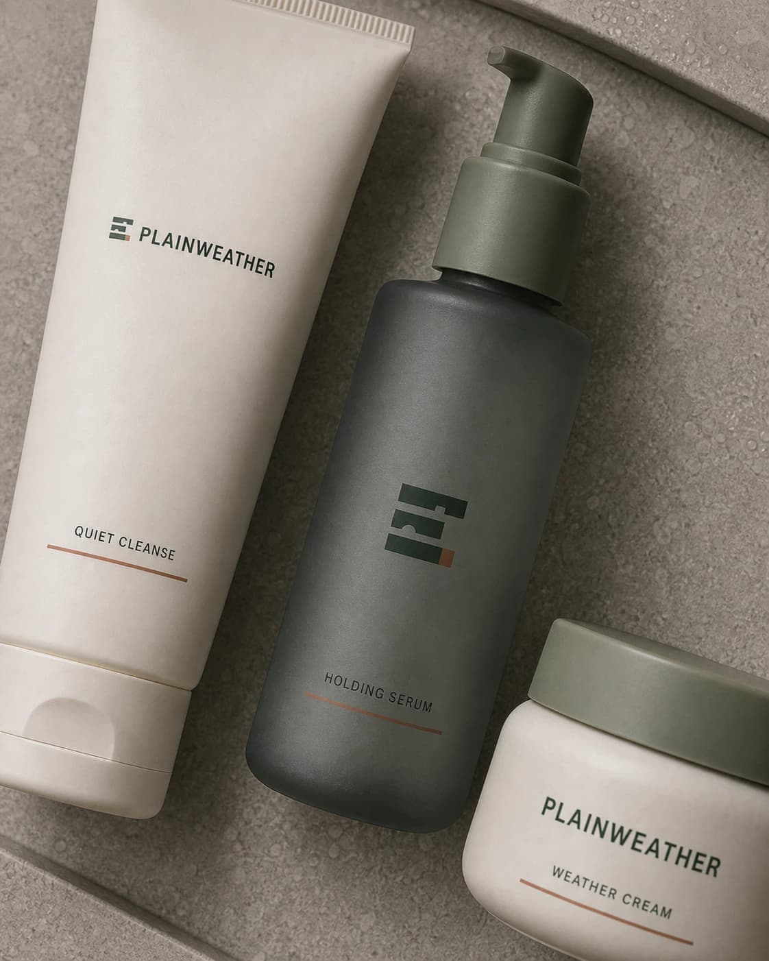 Close view of Plainweather cleanser, serum, and cream showing the wordmark and logomark packaging system